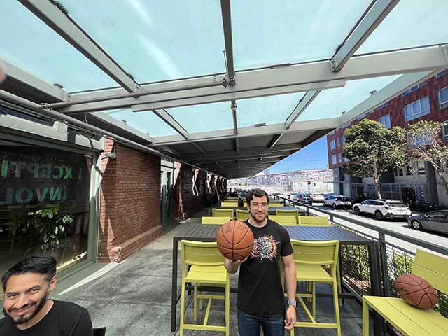 Photo of two people and basketballs illustrating marginal distoriton in picture corners